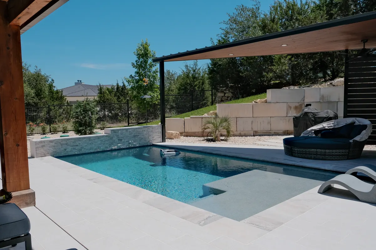 Shaded pavilion and lounge at the edge of an Ambia pool